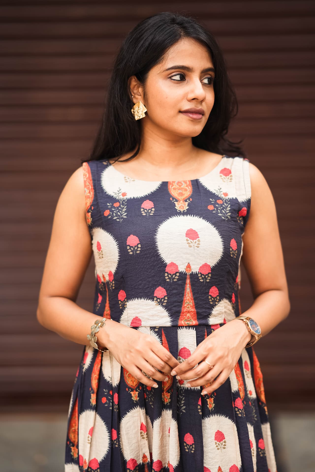 Closer view of the navy floral dress and gold jewellery.