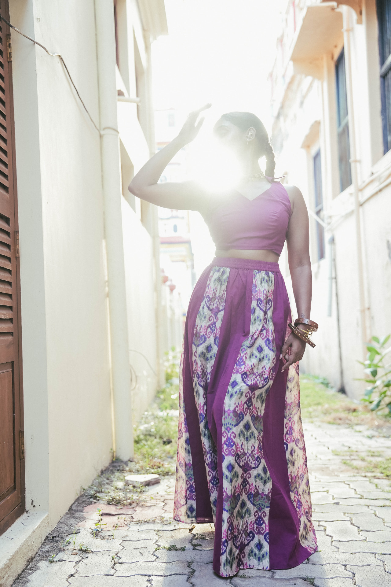 Model wearing wide purple ikat panelled palazzo trousers with a mauve fitted bralette top.