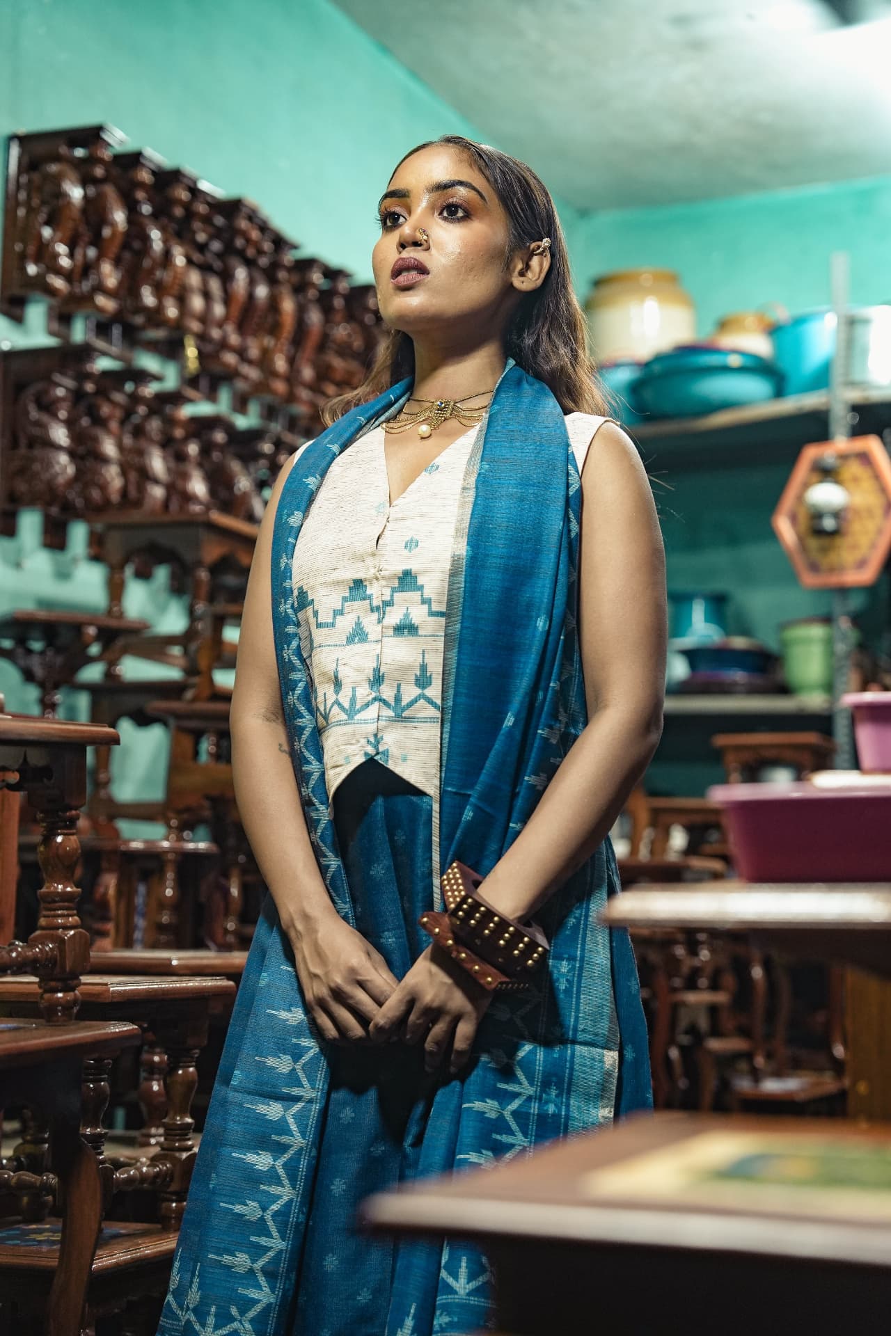 Close view of the indigo kurta and ivory waistcoat print detail.