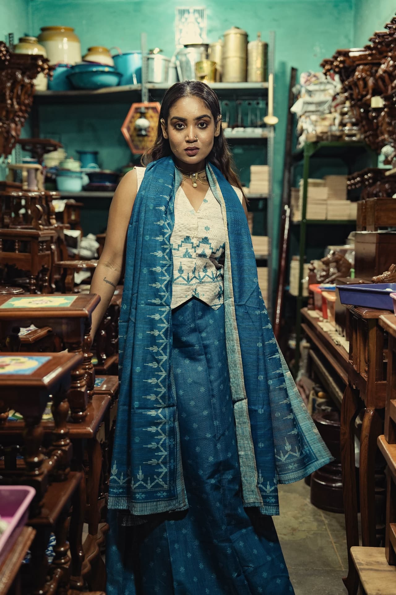 Model wearing an indigo handwoven kurta with an ivory printed waistcoat and matching dupatta.